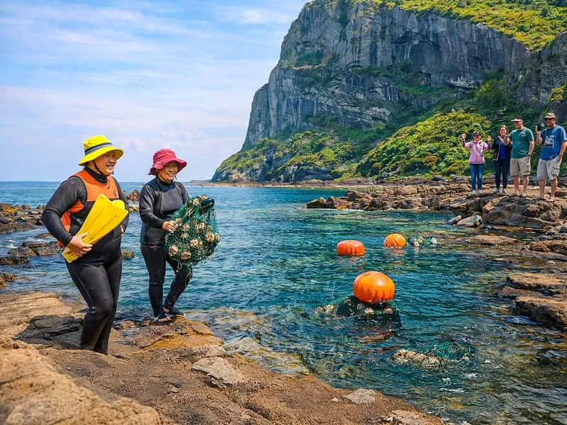 Seongsan Ilchulbong sunrise peak rising from the sea on a tour of Jeju Island Korea, South Korea